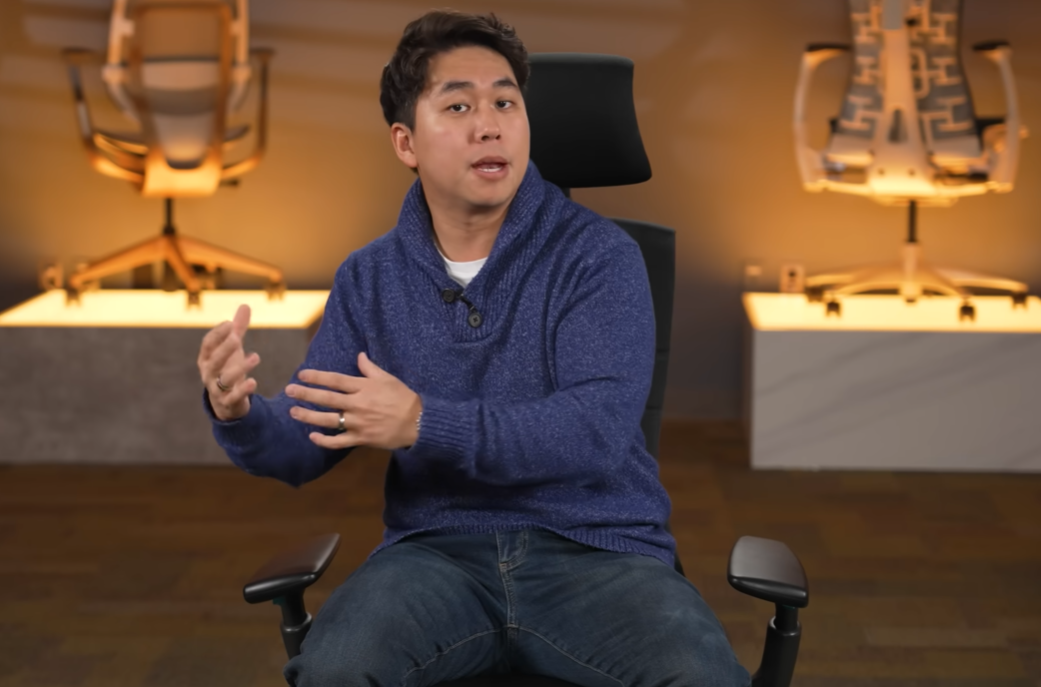 Dan Ahn (Ahnestly) seated on a black Herman Miller Embody chair